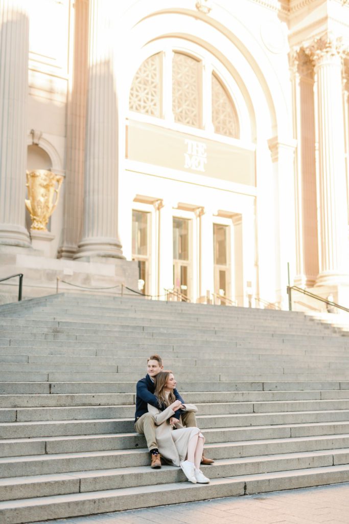 couple on steps in front of The MET